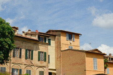 Tuscany row of houses in Italy with blue sky 