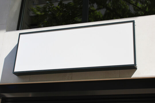 Large white billboard banner on an office or storefront mockup. Blank white office or shop sign mock up template.