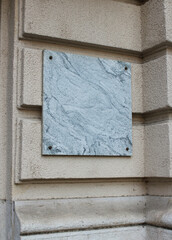 Blank marble sign on a wall of a building mockup. Empty marble signage of a restaurant or shop sign mock up template.