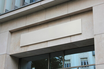 Large white billboard banner on a bank, office or storefront mockup. Blank white office or shop sign mock up template.