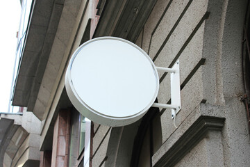 Rounded Street storefront shop, cafe, restaurant mounted signboard mock up design template. Blank white store sign design mockup.