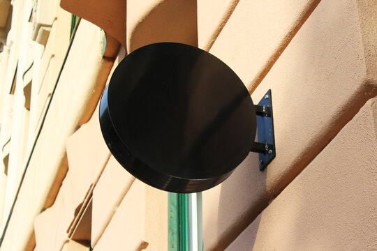 Rounded Street storefront shop, cafe, restaurant mounted signboard mock up design template. Blank white store sign design mockup.