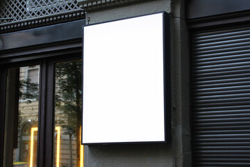 Large white billboard banner on an office or storefront mockup. Blank white office or shop sign mock up template.