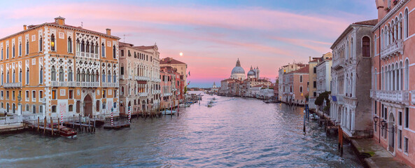 Sunset panoramic view of the Grand Canal in Venice, Italy, with the iconic dome and vibrant sky © Kavalenkava