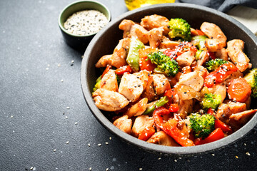 Chicken stir fry and vegetables and sesame in the wok. Traditional Asian cuisine.
