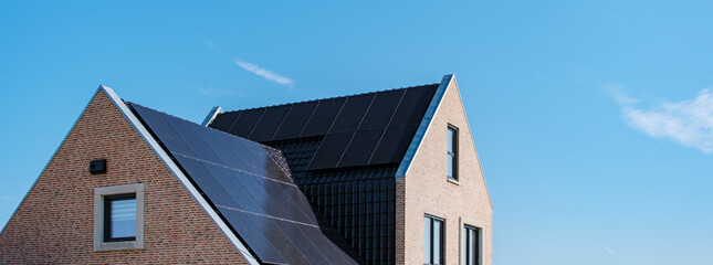 Modern Home With Solar Panels Under Clear Blue Sky