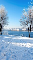 A winter landscape showcases a snowy park with trees and a historic building under a bright blue sky dotted with clouds