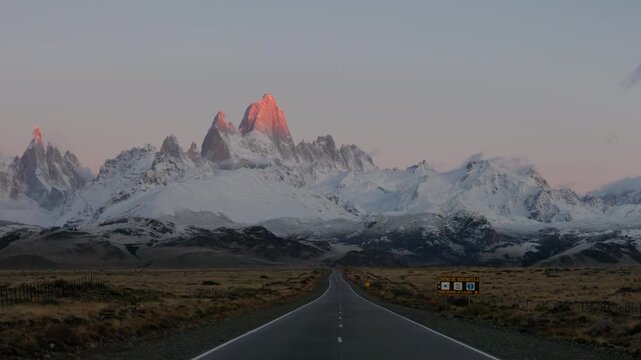 a close zoom in shot of monte fitz roy and the road to el chalten at sunrise in patagonian argentina