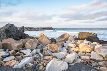 beach background for summer travel with rock beach, beautiful blue sea and  cloudy sky