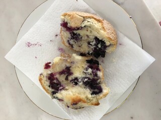 A nice blueberry muffin breakfast split in half 