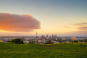 Sunset over Sky tower with skyscraper from Mount Eden at Auckland