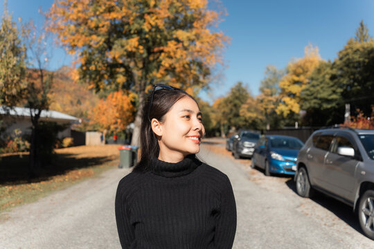 Beautiful young asian woman strolling in arrowtown during autumn season