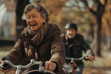 Cheerful active elderly couple in public park riding bicycles