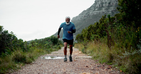 Running, senior or black man on path for fitness, health and wellness in retirement to exercise. Body mobility, runner and male person on trail in nature for workout, cardio performance and training