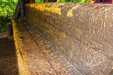 Bench in the woods with tons of carvings