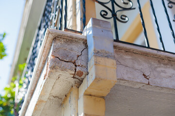 cracked balcony on a building facade