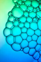 Fototapeta premium Abstract background bio technology, macro photography foam and water with gradient background. Molecule multicolor backgorund