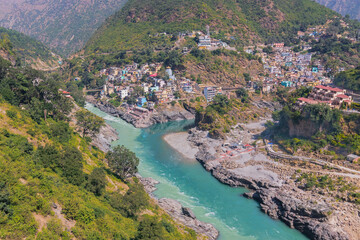 Bhagirathi river from left side and Alakananda river with turquoise blue colour from right side converge at Devprayag,Holy conflunece and form river Holy Ganges thereafter.Garhwal, Uttarakhand, India.