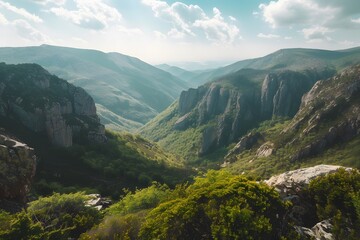 Obraz premium Breathtaking mountain view with lush greenery and dramatic cliffs in the background.