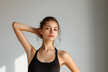 Fototapeta premium Graceful Young Ballet Dancer Posing Elegantly Against a Serene White Background