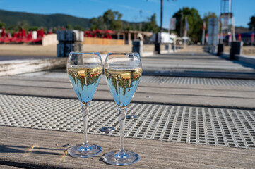 Summer time in Provence, two glasses of cold champagne cremant sparkling wine on famous Pampelonne sandy beach near Saint-Tropez in sunny day, Var department, France, beach club party
