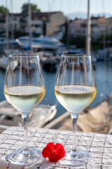 Glasses of cold white Cote de Provence wine in yacht harbour of Port Grimaud, summer vacation on French Riviera in Provence, France, wine tasting