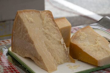 Traditional italian food, 36 months aged in caves Italian parmesan hard cheese from Parmigiano-Reggiano, Italy on farmers market