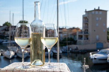Glasses of cold white Cote de Provence wine in yacht harbour of Port Grimaud, summer vacation on French Riviera in Provence, France, wine tasting