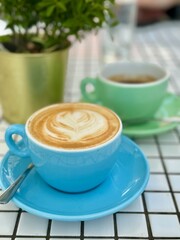 Cappuccino and Coffee Cups at Cafe