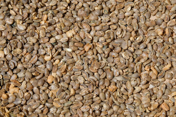 Abstract pattern and texture of sun-dried coffee. Coffee whose skin is cleaned and dried in the sun. Abstract shapes, patterns and techniques. Rural coffee farmer