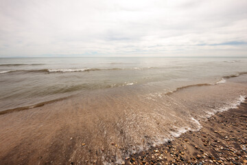 A relatively calm Lake Michigan washed on shore at Kohler Andrae State Park, Sheboygan, Wisconsin in early September