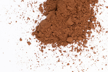 Cocoa powder scattered on white background close-up