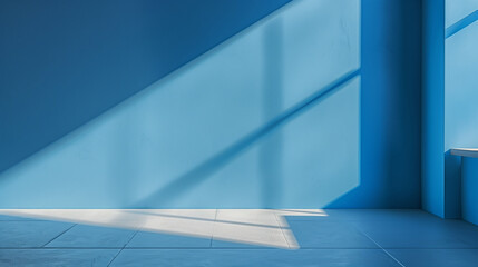 Obraz premium Minimalist plain blue background for product photography, soft shadow from sunlight window