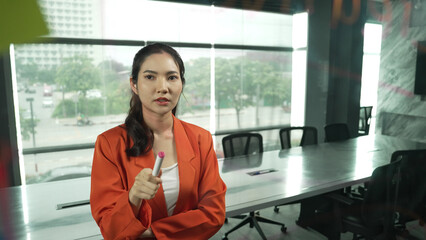 Professional young beautiful businesswoman thinking while standing at glass board with colorful sticky notes with marketing idea written. Portrait of project manager looking at mind map. Manipulator.