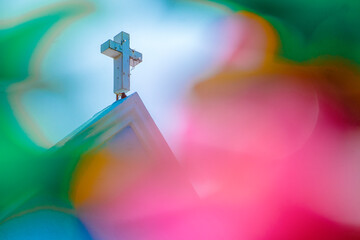 Christian cross stands proudly on the top of the church.