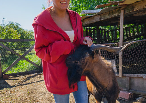 Teen goat herder with ram