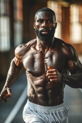 Fototapeta premium Muscular Man Running Indoors in Gym, Focused on Fitness and Strength Training, Wearing White Shorts, Intense Workout Session