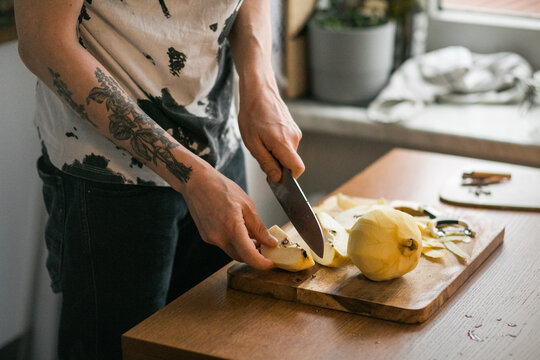 Slicing Peeled Quince on Cutting Board