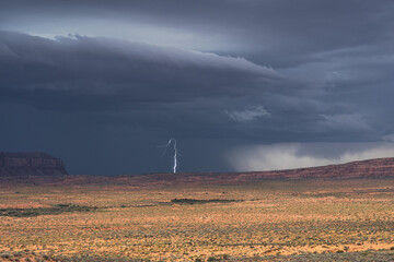 Dramatic storm over Monument Valley with lightning strike