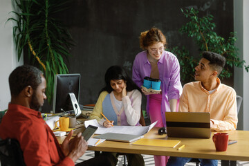 Creative office friendly colleagues. Bringing workers coffee