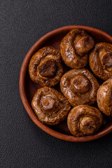 Delicious juicy whole champignons baked on the grill with salt and spices