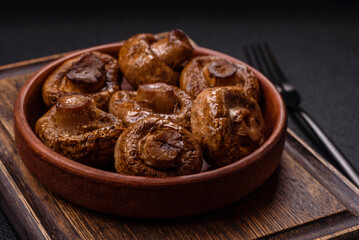 Delicious juicy whole champignons baked on the grill with salt and spices