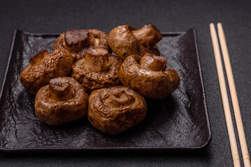 Delicious juicy whole champignons baked on the grill with salt and spices
