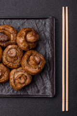 Delicious juicy whole champignons baked on the grill with salt and spices