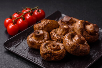 Delicious juicy whole champignons baked on the grill with salt and spices