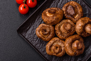 Delicious juicy whole champignons baked on the grill with salt and spices