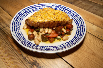 A delicious plate of a Rarebit pork chop with summer bean salad