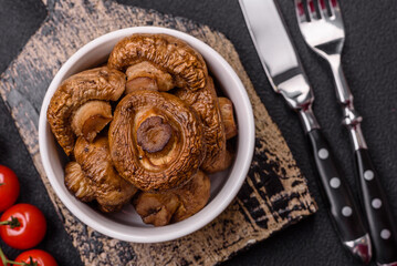 Delicious juicy whole champignons baked on the grill with salt and spices