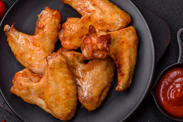 Delicious fried chicken wings with salt, spices and herbs