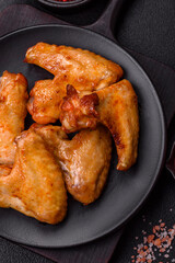 Delicious fried chicken wings with salt, spices and herbs